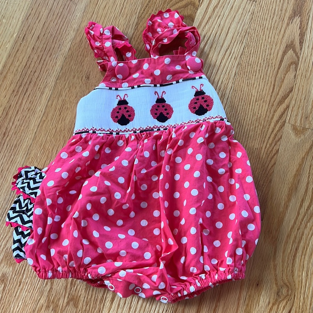 Baby girl smocked ladybug romper with snaps.